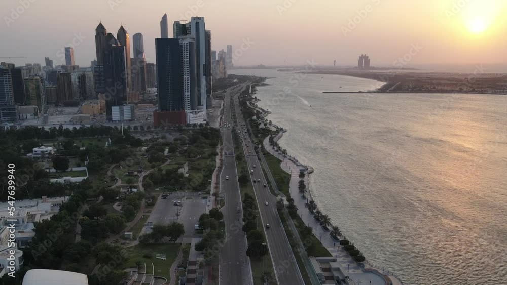 Wall mural Aerial view of Abu Dhabi corniche at sunset, slow motion