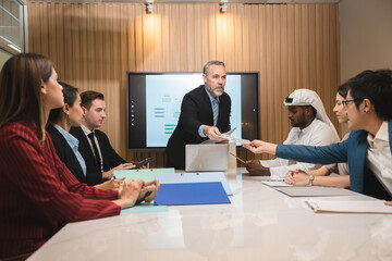 Serious diverse business team leader discuss financial paperwork, Smart businessman and businesswoman partner teamwork talking discussion in group meeting at office table in modern office interior
