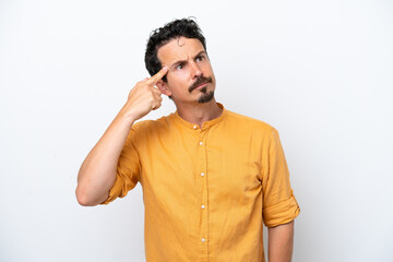 Young man with moustache isolated on white background making the gesture of madness putting finger on the head