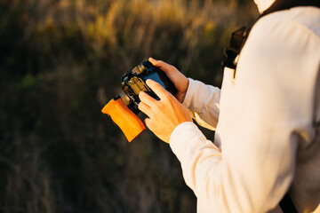 Close up of a man's hands using his digital camera at countryside