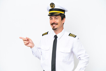 Airplane caucasian pilot isolated on white background pointing finger to the side