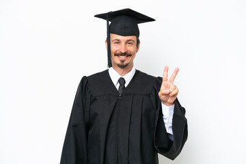 Young university graduate man isolated on white background smiling and showing victory sign