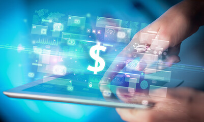 Close-up of a hand using tablet, currency concept