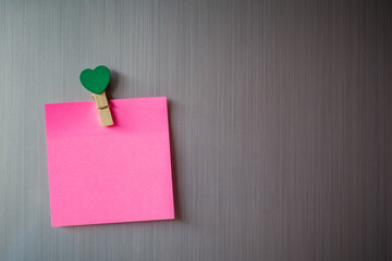 Abstract of wooden heart clip with Blank paper and stick paper on refrigerator door. paper note copy space for add text. valentine picture message background