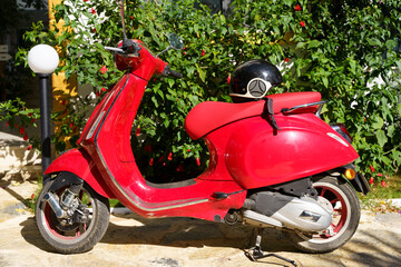 Scooter on the street of the tourist town. Classic scooter for riding and renting during holidays, vacations and travel for tourists.
