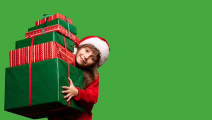 A girl in a Santa hat holds a lot of gifts for Christmas and New Year 2023. Happy childhood. Sale and Black Friday