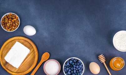 The process of making cheesecakes from prepared ingredients on a dark background with space for text.