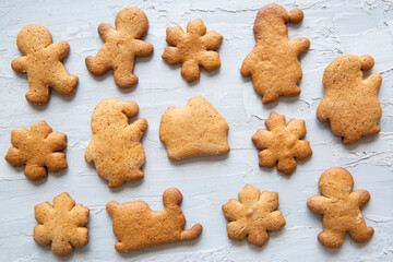 Assortment of gingerbread cookies on grey table background, top view. 