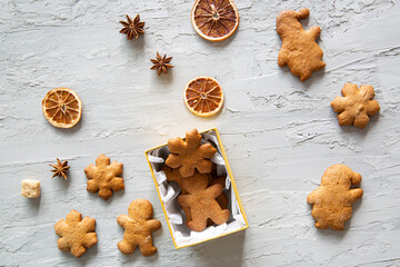 Christmas gingerbread cookies in present box and on the table, top view. Tasty present. 