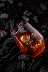  Whiskey with ice  on a background of burning charcoal.