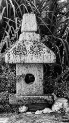 Garden decorations made of stones and stone sculptures among nice greens.