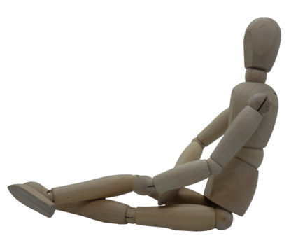 Wooden jointed figure sitting on ground with legs crossed and hands in lap