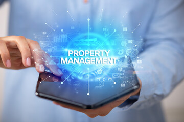 Businessman holding a foldable smartphone, new business concept