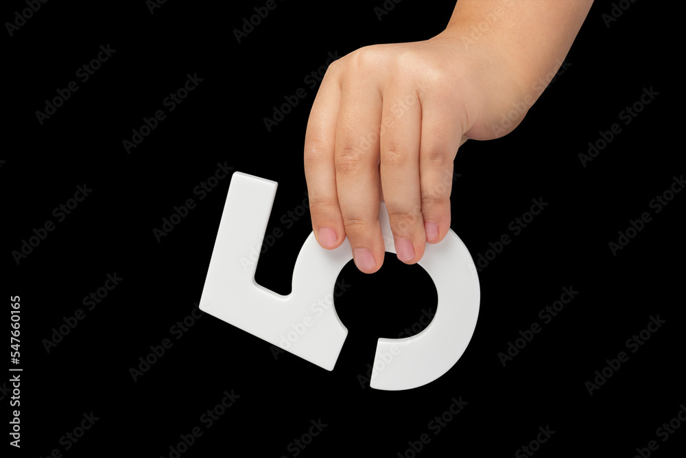 Poster number five in hand isolated on black background. number five in the hand of a child holding on a bl