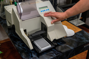 Hands with test tubes close-up. Hands in medical gloves hold tubes. Concept blood test for the presence of a virus. Viral disease test. Human blood in the laboratory. Virusology.
