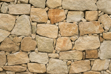 Background beautiful dry masonry consisting of very large and very small stones