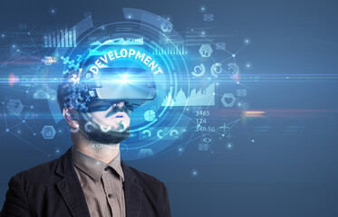 Businessman looking through VR glasses