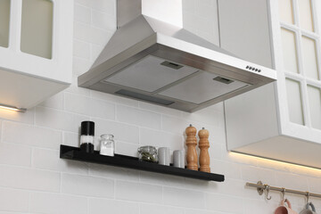 Modern range hood over shelf with spices in kitchen - obrazy, fototapety, plakaty