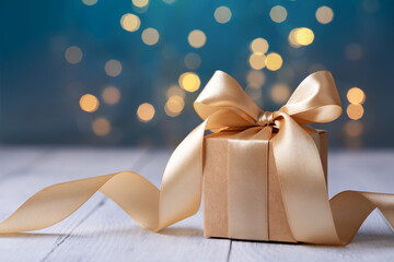 Christmas or birthday gift box on white wooden table against blue turquoise bokeh lights. Holiday...