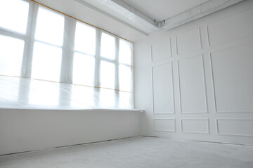 Window covered with plastic film in room after renovation