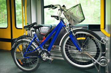 Different bicycles with big wheels in tram
