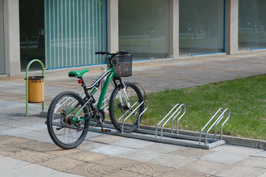 Metal bike parking rack with bicycle on city street
