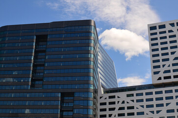 View of beautiful modern building in city against blue sky