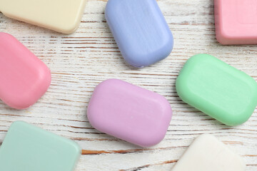 Many different soap bars on wooden table, flat lay