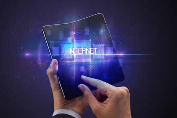 Businessman holding a foldable smartphone