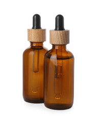 Bottles of essential oil on white background