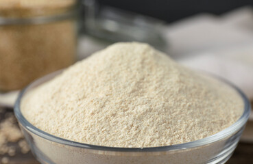 Glass bowl with quinoa flour, closeup view