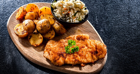 Chicken cutlet coated with breadcrumbs with potatoes and cabbage
