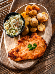 Chicken cutlet coated with breadcrumbs with potatoes and cabbage