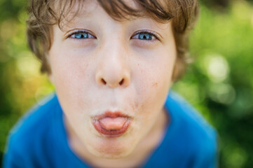 face portrait boy grimace, showing tongue