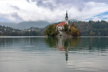 Fototapeta na wymiar Peaceful view on lake Bled and the island with its pilgrimage church Assumption of Mary, Slovenia