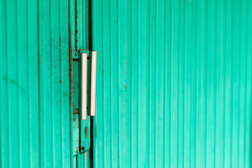 Photo of the handle on the green rolling door.