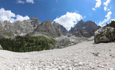 scree of white stones in the middle of the Italian Alps in summer