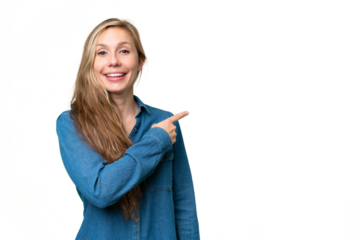 Young blonde woman over isolated background pointing to the side to present a product