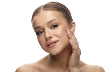 Fototapeta premium Woman with beauty face touching healthy facial skin portrait. Beautiful smiling girl model with natural makeup touching glowing skin on white background close up. Skin care.