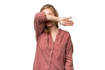 Young blonde woman over isolated background covering eyes by hands