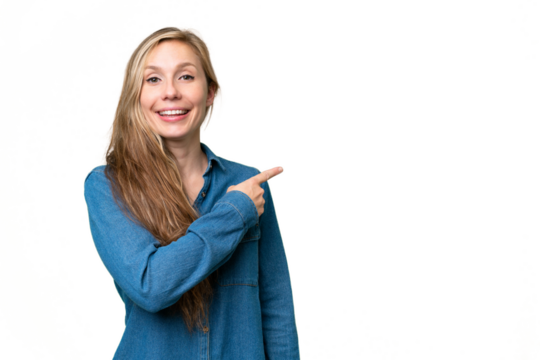 Young blonde woman over isolated background pointing to the side to present a product