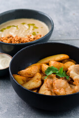 Lunch mushroom cream soup and fish with chips in bowls