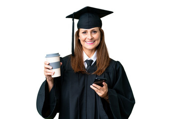 Middle age university graduate woman over isolated background holding coffee to take away and a mobile