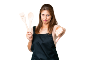 Middle age caucasian woman holding a rolling pin over isolated background showing thumb down with negative expression