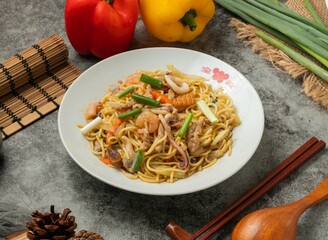 Mixed shrimp Chow Mein with chopsticks served in dish isolated table top view of chinese food