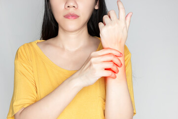 Women is rubbing wrist with pain syndrome and feel numb