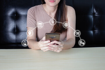 Asian woman is on social media by smartphone to do shopping online on black Friday sale with graphic element icon.