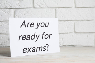 Obraz premium Paper with question Are you ready for exams on white wooden table