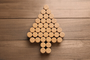 Christmas tree made of wine corks on wooden table, top view