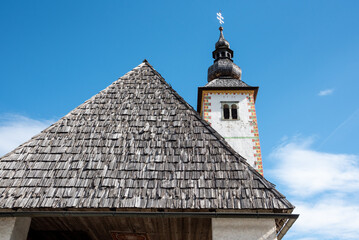 Fototapeta na wymiar Old church St. John the Baptist at Lake Bohinj in the Triglav National Park, The Julian Alps in Slovenia